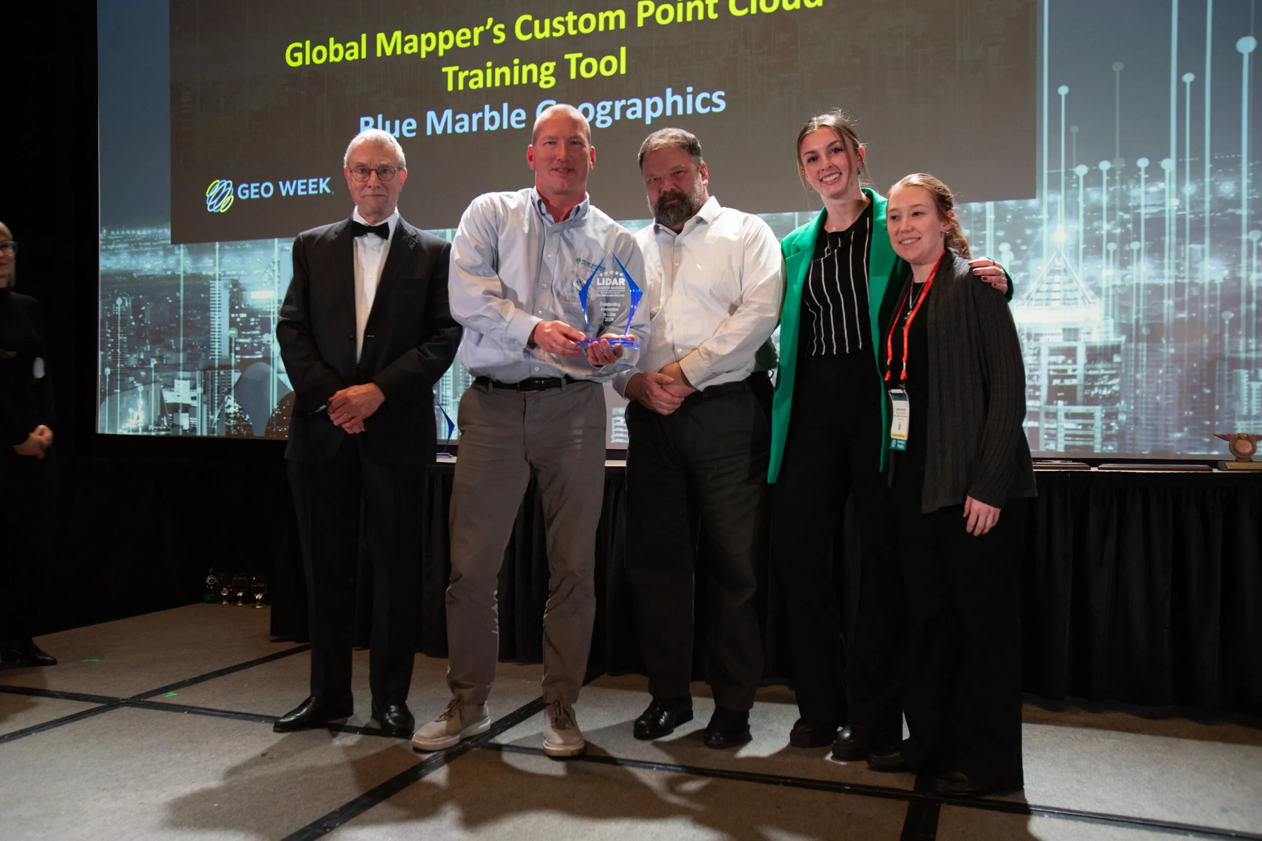 Blue Marble Geographics employees accept the 2024 Innovation in Lidar award at Geoweek